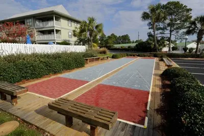 a basketball court with two benches and a basketball hoop at Cute ground floor condo with shared pool access to shuffleboard and tennis in Santa Rosa Beach