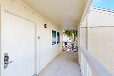 a bike is parked on the side of a building at Courtyard view condo with private beach access private balcony & free WiFi in Santa Rosa Beach