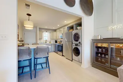 a kitchen with a washer and dryer at Courtyard view condo with private beach access private balcony & free WiFi in Santa Rosa Beach