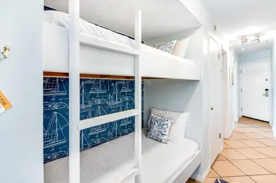 a room with bunk beds with blue drawings on the walls at Oceanfront condo with pool access washer&dryer central AC and ocean view in Santa Rosa Beach