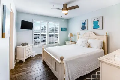 a bedroom with a bed and a ceiling fan at Oceanfront condo with pool access washer&dryer central AC and ocean view in Santa Rosa Beach