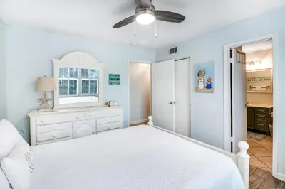 a bedroom with a white bed and a window at Oceanfront condo with pool access washer&dryer central AC and ocean view in Santa Rosa Beach
