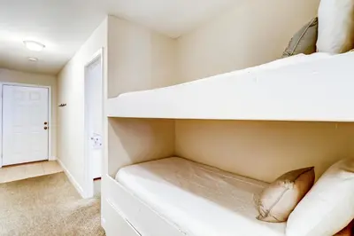 a bedroom with two bunk beds and a hallway at Picturesque gulf-front condo on 30A Steps to beach Charcoal grills on-site in Santa Rosa Beach