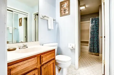 a bathroom with a white sink and a toilet at Picturesque gulf-front condo on 30A Steps to beach Charcoal grills on-site in Santa Rosa Beach