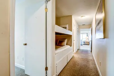 a hallway with bunk beds in a house at Picturesque gulf-front condo on 30A Steps to beach Charcoal grills on-site in Santa Rosa Beach