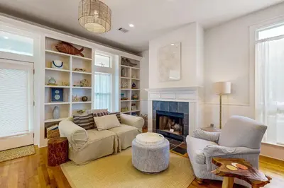 a living room with a couch and a fireplace at Colorful house near the beach with shared swimming pool in Santa Rosa Beach