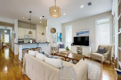 a living room with a couch and a table at Colorful house near the beach with shared swimming pool in Santa Rosa Beach