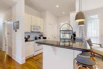 a kitchen with white cabinets and a counter top at Colorful house near the beach with shared swimming pool in Santa Rosa Beach