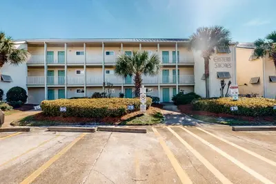 an empty parking lot in front of a hotel at Lovely first floor condo with ocean views patio & grill - steps from the beach in Santa Rosa Beach