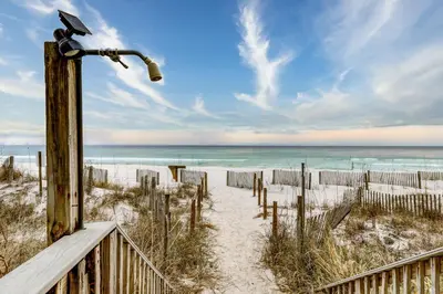 a wooden path to the beach with a telescope at Charming gulf-front 2nd floor condo in South Walton Outdoor showers on-site in Santa Rosa Beach