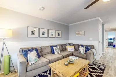 a living room with a couch and a table at Luxury home with private saltwater pool spa gazebo & deck - walk to beach in Santa Rosa Beach