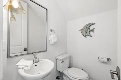 a bathroom with a sink and a toilet and a mirror at Seagrove Serenity 4BR Coastal Retreat with Pool & Bikes in Santa Rosa Beach