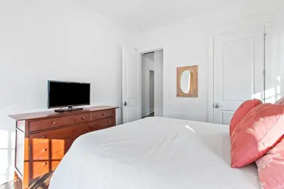 a bedroom with a bed and a television on a dresser at Seagrove Serenity 4BR Coastal Retreat with Pool & Bikes in Santa Rosa Beach