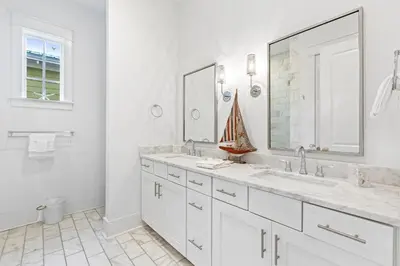 a white bathroom with two sinks and a large mirror at Seagrove Serenity 4BR Coastal Retreat with Pool & Bikes in Santa Rosa Beach