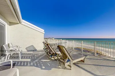 a balcony with chairs and the ocean in the background at Fourth floor oceanfront condo with pool access ocean views and washer&dryer in Santa Rosa Beach