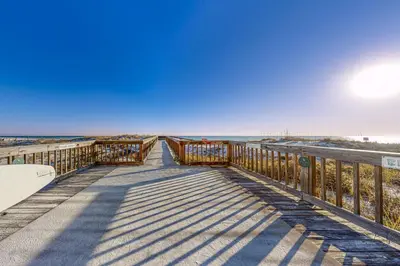 a boardwalk leading to the beach on a sunny day at Fourth floor oceanfront condo with pool access ocean views and washer&dryer in Santa Rosa Beach