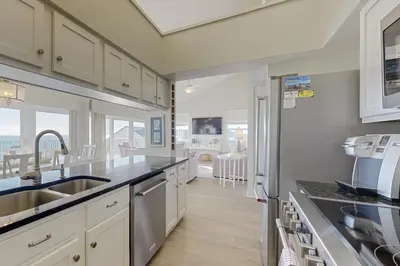 a kitchen with a sink and a counter top at Fourth floor oceanfront condo with pool access ocean views and washer&dryer in Santa Rosa Beach