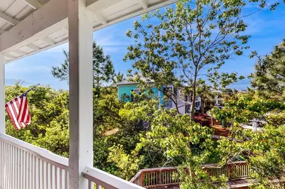 a view from the porch of a house with an american flag at Dog-friendly bungalow with on-site pool hot tub free WiFi and washer&dryer in Santa Rosa Beach