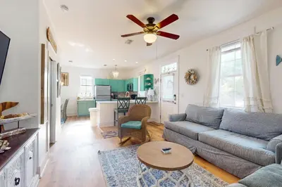 a living room with a couch and a ceiling fan at Dog-friendly bungalow with on-site pool hot tub free WiFi and washer&dryer in Santa Rosa Beach