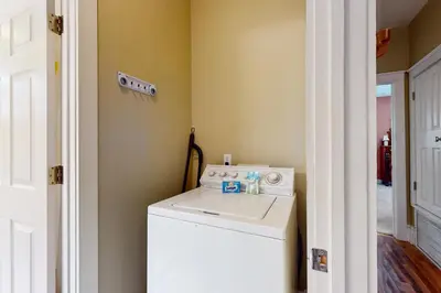 a laundry room with a washer and dryer next to a door at Coastal haven near the beach off scenic 30A with two pools & porch- dog-friendly in Santa Rosa Beach