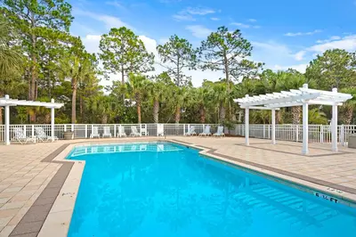 a swimming pool with a pergola and a swimming poolvisor at Coastal haven near the beach off scenic 30A with two pools & porch- dog-friendly in Santa Rosa Beach