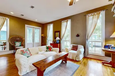 a living room with a white couch and a table at Coastal haven near the beach off scenic 30A with two pools & porch- dog-friendly in Santa Rosa Beach
