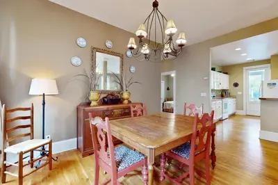 a dining room with a wooden table and chairs at Coastal haven near the beach off scenic 30A with two pools & porch- dog-friendly in Santa Rosa Beach