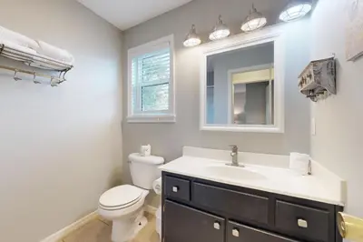 a bathroom with a toilet and a sink and a mirror at Seagrove Beach condo with AC pool & tennis - steps from the Gulf of Mexico in Santa Rosa Beach