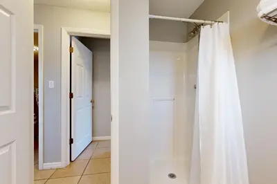 a white closet with a shower curtain in a hallway at Seagrove Beach condo with AC pool & tennis - steps from the Gulf of Mexico in Santa Rosa Beach