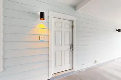 a white door in a room with a wall at Seagrove Beach condo with AC pool & tennis - steps from the Gulf of Mexico in Santa Rosa Beach