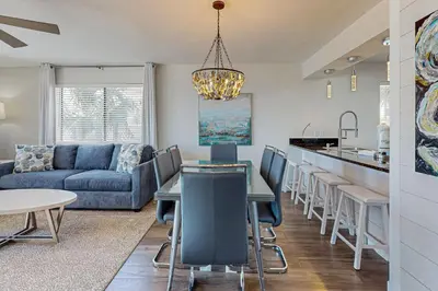 a living room with a couch and a table at Delightful Beach Getaway with Water Views Beach Access Deck & Fast WiFi in Santa Rosa Beach