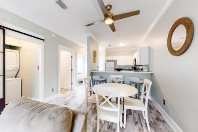 a kitchen and dining room with a table and chairs at Peaceful condo with pool access central AC and washer&dryer in Santa Rosa Beach
