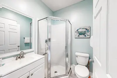 a bathroom with a shower and a toilet and a sink at Peaceful condo with pool access central AC and washer&dryer in Santa Rosa Beach