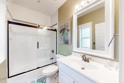 a bathroom with a toilet and a sink and a mirror at Peaceful condo with pool access central AC and washer&dryer in Santa Rosa Beach