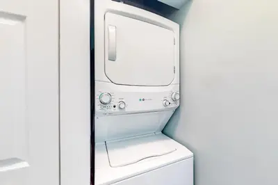 a washer and dryer in a bathroom with a mirror at Peaceful condo with pool access central AC and washer&dryer in Santa Rosa Beach
