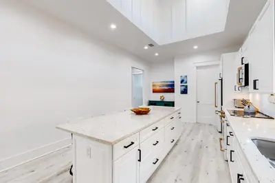 a kitchen with white cabinets and a white counter top at Spacious open concept one story home with pool bikes grill and pet friendly in Santa Rosa Beach
