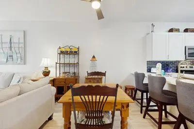 a living room with a couch and a table at Third-floor condo with pool washer&dryer fast WiFi & central AC - near beach in Santa Rosa Beach