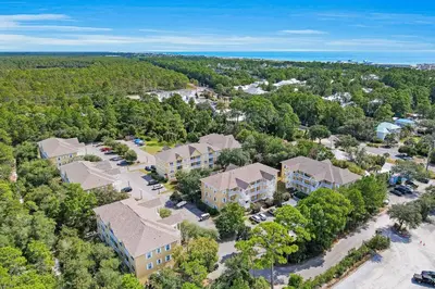 an aerial view of a house with a parking lot at Third-floor condo with pool washer&dryer fast WiFi & central AC - near beach in Santa Rosa Beach