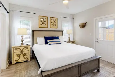 a bedroom with a large bed and two lamps at Dog-friendly home with pool patio & washer&dryer in Santa Rosa Beach