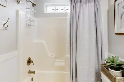 a bathroom with a shower with a shower curtain at Dog-friendly home with pool patio & washer&dryer in Santa Rosa Beach