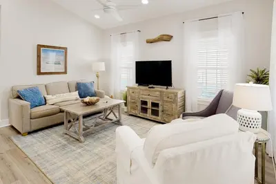a living room with a couch and a tv at Dog-friendly home with pool patio & washer&dryer in Santa Rosa Beach
