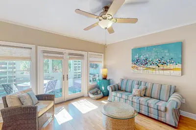 a living room with a couch and a ceiling fan at 2nd-floor condo near beach with outdoor pool tennis balcony washer&dryer AC in Santa Rosa Beach