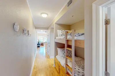 a hallway with bunk beds in a room at 2nd-floor condo near beach with outdoor pool tennis balcony washer&dryer AC in Santa Rosa Beach