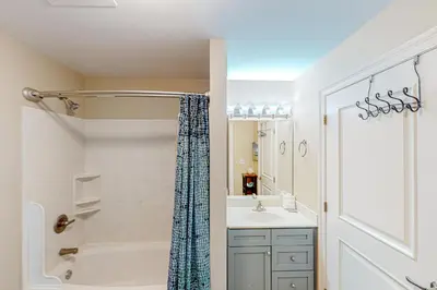 a bathroom with a tub and a sink and a shower at 2nd-floor condo near beach with outdoor pool tennis balcony washer&dryer AC in Santa Rosa Beach