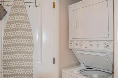 a bathroom with a toilet and a washing machine at 2nd-floor condo near beach with outdoor pool tennis balcony washer&dryer AC in Santa Rosa Beach