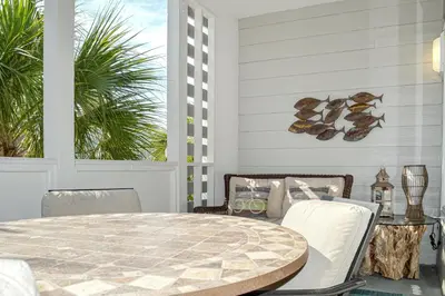 a dining room with a table and chairs at 2nd-floor condo near beach with outdoor pool tennis balcony washer&dryer AC in Santa Rosa Beach