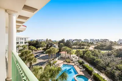 a view of the pool from the balcony of a resort at Comfortable studio with shared outdoor pool hot tub BBQ area and pool views in Seacrest