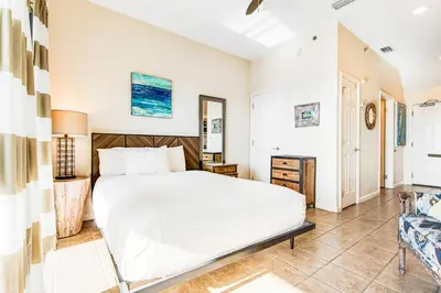 a bedroom with a large white bed in a room at Comfortable studio with shared outdoor pool hot tub BBQ area and pool views in Seacrest