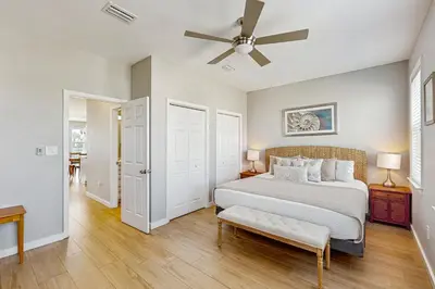 a bedroom with a bed and a ceiling fan at Spacious Seabreeze Trail home with gulf views & shared pool - short walk to beach in Seacrest