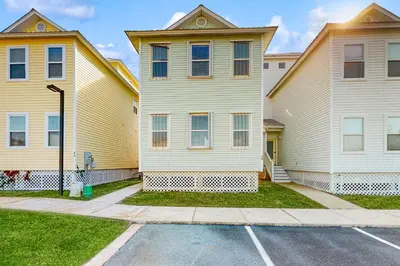 a couple of houses with a parking lot at Spacious Seabreeze Trail home with gulf views & shared pool - short walk to beach in Seacrest